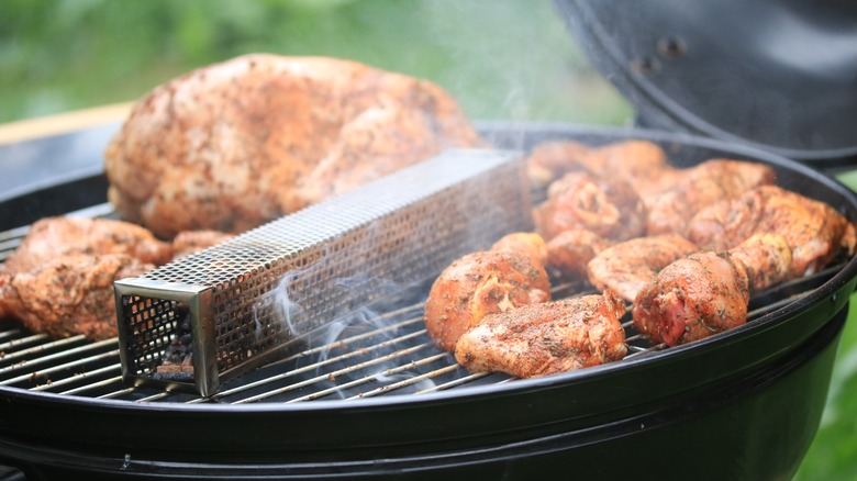 Smoker box and meat on a grill